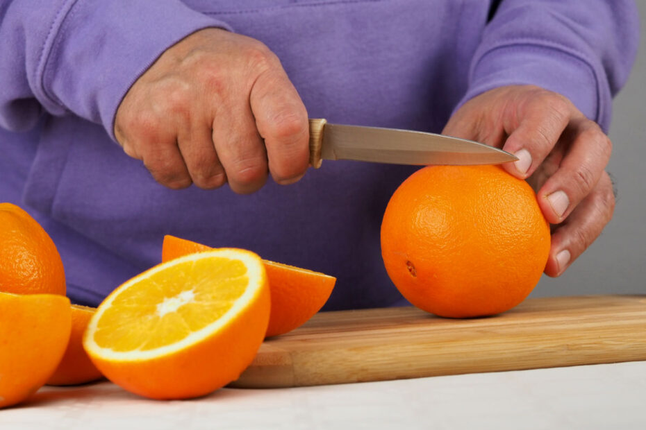 a-man-cuts-oranges-with-a-knife-003