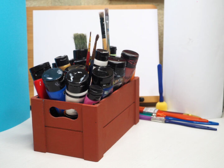 Box with paints and paint brushes