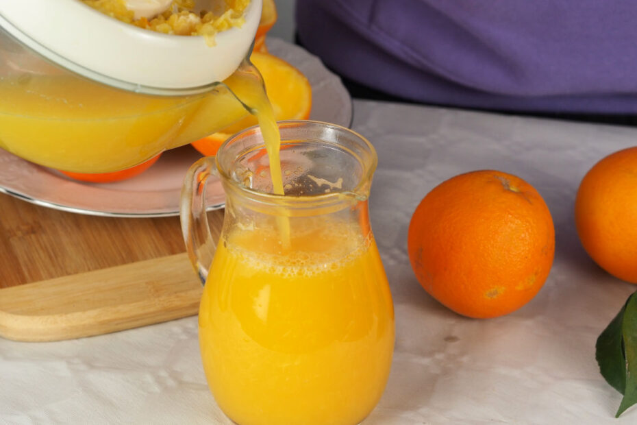 fresh-orange-juice-being-poured-into-a-glass-jug-038