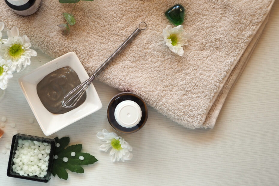 Green clay cosmetic face mask in a white porcelain bowl